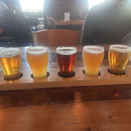 A flight of IPA's plus an orange brewlius.