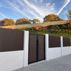 LA Fence Craft - Beautiful Composite Double Gate in the Color Ipe and Fluted Panel Fence.