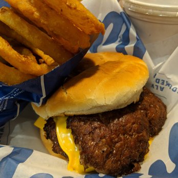 Culver's - Tasty burger with completely melted cheese and a side of thin, crispy onion rings. - Burgers Near Me - Livonia, Michigan