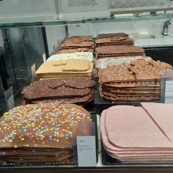 Läderach chocolatier suisse - Slabs of all kinds of mixed chocolate, they break off what you want by weight - Chocolatiers & Shops Near Me - Washington, DC, District of Columbia