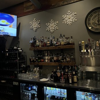 Bar Nova - shelves of liquor and a television - Beer, Wine & Spirits Near Me - Avon, Ohio