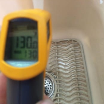 Eagle's Nest Inspections - Checking the water temperature at a kitchen sink. Temperature is over the Recommended 115 - 120 F - Home Inspectors Near Me Eagle's Nest Inspections - Checking the water temperature at a kitchen sink. Temperature is over the Recommended 115 - 120 F - Home Inspectors Near Me
