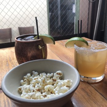 Radiator Whiskey - The Bourbon Margarita and the Strawberry Mule with the complimentary popcorn yumm - New American Near Me - Seattle, Washington