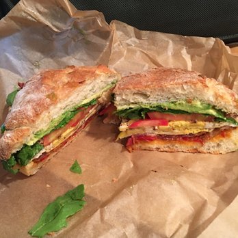 Bread & Spread - Breakfast sandwich with egg, arugula, tomato, bacon, avocado + red pepper jam and green aji sauce. Get it! - Coffee & Tea Near Me - Brooklyn, New York