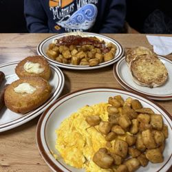 Scrambled eggs with sausage links, the blueberry muffin on the griddle and homefries