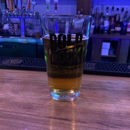 a glass of beer on a bar a glass of beer on a bar