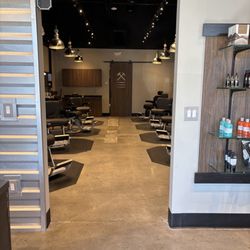 Nothing says luxury like a concrete floor, a small colony of ants, and barber chairs that seem like Cheesecake Factory booster seats.