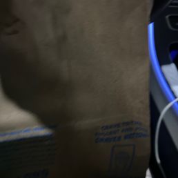 a brown paper bag sitting on top of a computer keyboard a brown paper bag sitting on top of a computer keyboard