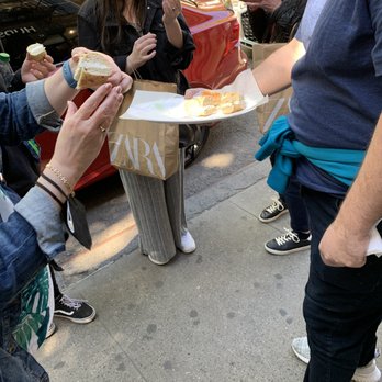 Hudson Bagels - a man handing a sandwich to a woman - Bagels Near Me - New York, New York Hudson Bagels - a man handing a sandwich to a woman - Bagels Near Me - New York, New York