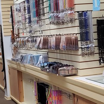 Cross In the Woods - Wall of assorted colored Rosaries.  10/22/2019 - Churches Near Me - Indian River, Michigan
