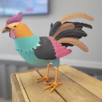 OX-B's - a colorful bird on a wooden table - Chicken Wings Near Me - Pataskala, Ohio