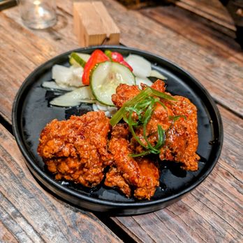 Oseyo - a plate of food on a wooden table - Korean Near Me - Austin, Texas