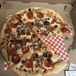 Pizza with pepperoni, sausage, black olives, and pineapple Pizza with pepperoni, sausage, black olives, and pineapple