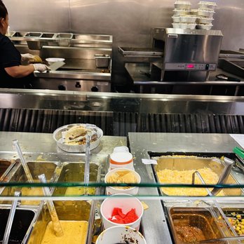Costa Vida - a man preparing food in a restaurant kitchen - Mexican Near Me - Aurora, Colorado