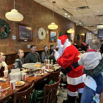 Mangiamo - a man dressed as santa claus at a restaurant - Pizza Near Me - Paramus, New Jersey