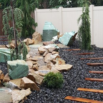 Green With Envy Yard Care - a garden with a waterfall - Landscaping Near Me - Boise, Idaho