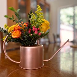 Petals And Decor - Gorgeous floral arrangement in a decorative water can provided by customer