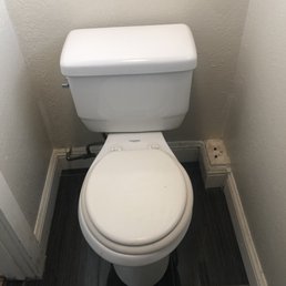 a toilet in a small bathroom a toilet in a small bathroom