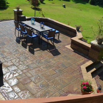Traditions Landscape Group - a patio with a table and chairs - Landscaping Near Me - Westerville, Ohio Traditions Landscape Group - a patio with a table and chairs - Landscaping Near Me - Westerville, Ohio