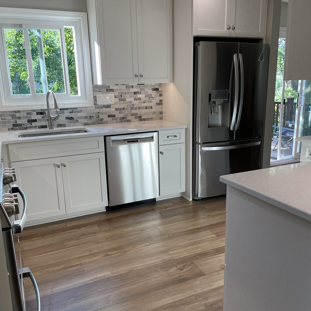 Anzalone Construction - a kitchen with white cabinets and stainless steel appliances - General Contractors Near Me - Aurora, Illinois