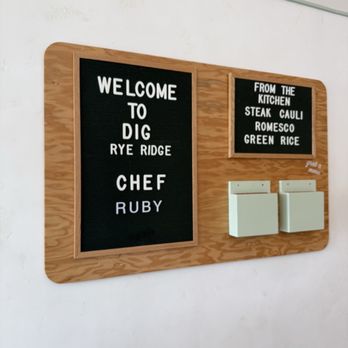 Dig Inn - Entrance menu dispenser acknowledging main chef - New American Near Me - Rye Brook, New York