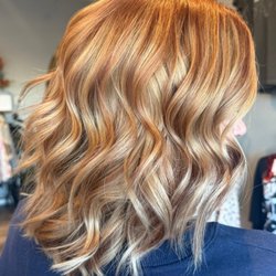 Pin-Up Curls - Gorgeous copper and blonde dimensional hair color with soft waves. Custom highlights at Pin-Up Curls in Fort Wayne.