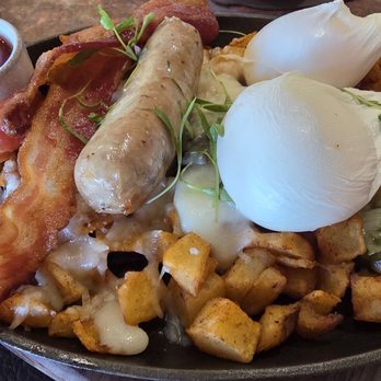Pradera Brunch - The breakfast skillet was good, with poached eggs, bacon and sausage, on top of diced potatoes with melted cheese. - Breakfast & Brunch Near Me - Costa Mesa, California Pradera Brunch - The breakfast skillet was good, with poached eggs, bacon and sausage, on top of diced potatoes with melted cheese. - Breakfast & Brunch Near Me - Costa Mesa, California