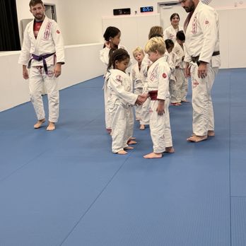 AMP BJJ Northwest Hills - Coaches Bree, Chris S., and Chris B. oversee the classes goodbye formation. - Martial Arts Near Me - Austin, Texas AMP BJJ Northwest Hills - Coaches Bree, Chris S., and Chris B. oversee the classes goodbye formation. - Martial Arts Near Me - Austin, Texas