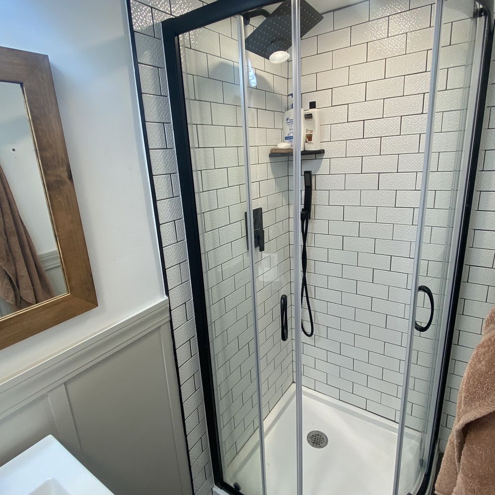 VR Piping & Heating - a bathroom with a shower and sink - Plumbing Near Me VR Piping & Heating - a bathroom with a shower and sink - Plumbing Near Me
