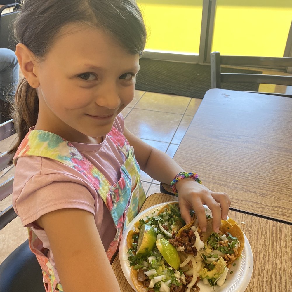 MexiTaco Humble - a young girl holding a plate of food - Food Trucks Near Me - Humble, Texas MexiTaco Humble - a young girl holding a plate of food - Food Trucks Near Me - Humble, Texas