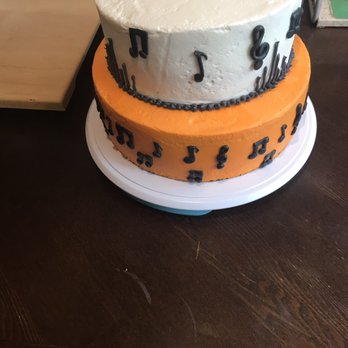 Delicias - a three tiered cake on a table - Desserts Near Me Delicias - a three tiered cake on a table - Desserts Near Me