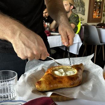 Georgian House Authentic Restaurant - Adjaruli Khachapuri mixed tableside - Modern European Near Me - Toronto, Ontario