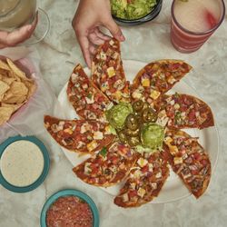 Chuy's - PANCHOS - Tostada chips, refried beans, cheese and your choice of fajita chicken, fajita beef or seasoned ground beef.