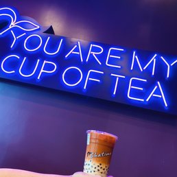 a person holding a cup of tea a person holding a cup of tea