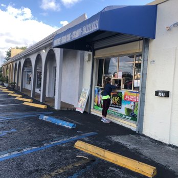 Tase - a woman standing outside of a restaurant - Juice Bars & Smoothies Near Me - Margate, Florida