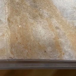 clear tape shows how far back the granite was cut to make the seams meet