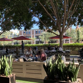 Olive & Ivy - a patio area with tables and umbrellas - Mediterranean Near Me - Phoenix, Arizona Olive & Ivy - a patio area with tables and umbrellas - Mediterranean Near Me - Phoenix, Arizona