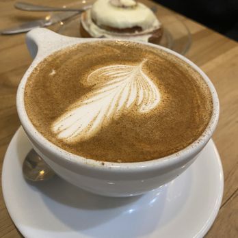 The Honeysuckle Coffee Co - Chai latte with poppyseed role in the background - Coffee & Tea Near Me - Sandy, Utah The Honeysuckle Coffee Co - Chai latte with poppyseed role in the background - Coffee & Tea Near Me - Sandy, Utah