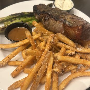 Woolley’s Kitchen & Bar - Top Sirloin with truffle fries and asparagus - Steakhouses Near Me - Bloomington, Minnesota Woolley’s Kitchen & Bar - Top Sirloin with truffle fries and asparagus - Steakhouses Near Me - Bloomington, Minnesota