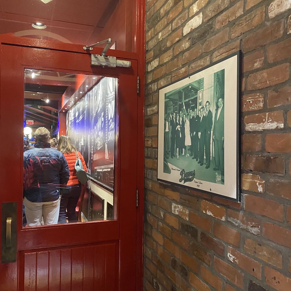 Dunn's - a man entering a restaurant through a red door - Poutineries Near Me - Montreal, Quebec Dunn's - a man entering a restaurant through a red door - Poutineries Near Me - Montreal, Quebec