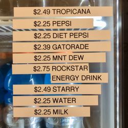 Dunkin' - Prices posted on refrigerator beverage case, July 2024