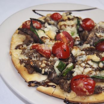 Pomodoro - Bella pizza. Ground sausage, portabella mushrooms, spinach, cherry tomatoes, goat cheese, olive oil, and balsamic reduction. - Italian Near Me - Loves Park, Illinois Pomodoro - Bella pizza. Ground sausage, portabella mushrooms, spinach, cherry tomatoes, goat cheese, olive oil, and balsamic reduction. - Italian Near Me - Loves Park, Illinois