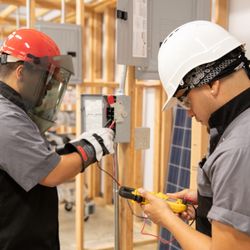 UEI College - Electrical Technician students working on assignments.
