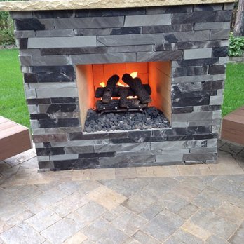 WillowGrove Landscape - a brick fireplace with a fire in it - Landscaping Near Me - Mandeville, Louisiana
