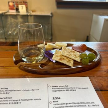 Castel Grisch Winery - a plate of cheese, crackers, grapes, and a glass of wine - Wineries Near Me - Watkins Glen, New York