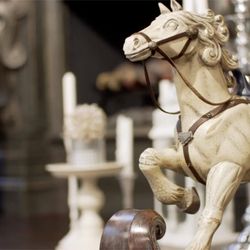 Avalon Estate Sales - Antique horse displayed in front of candle stock holders