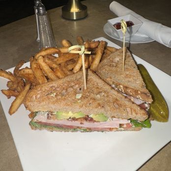 Martini Bar - Turkey club with avocado, bacon, lettuce, tomato, and aïoli sauce, toasted bread, delicious french fries and a pickle - Pubs Near Me - Chicago, Illinois