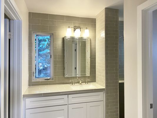 Bathroom Remodel - This home in Costa Mesa experienced extreme water and mold damage in the bathroom. Updated tiles, flooring and cabinets modernized and completely transformed the space.