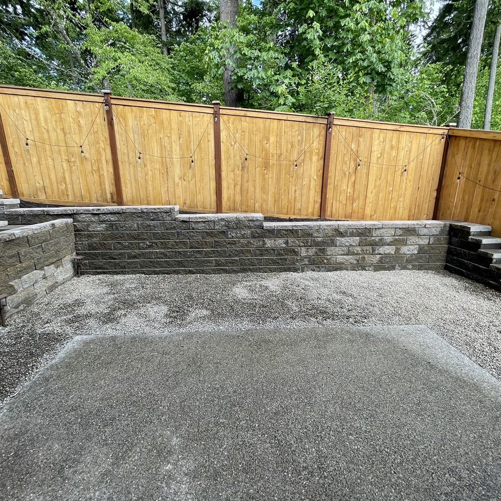 Daniel's Tree Service & Landscaping - Backyard renovation: final product of flattening out slope, retaining wall, replace mulch with gravel - Tree Services Near Me