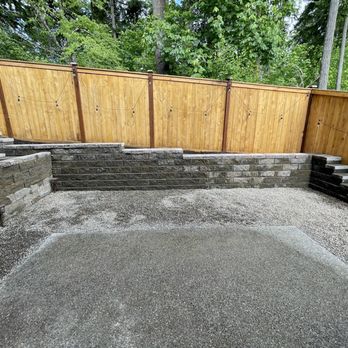 Daniel's Tree Service & Landscaping - Backyard renovation: final product of flattening out slope, retaining wall, replace mulch with gravel - Tree Services Near Me Daniel's Tree Service & Landscaping - Backyard renovation: final product of flattening out slope, retaining wall, replace mulch with gravel - Tree Services Near Me
